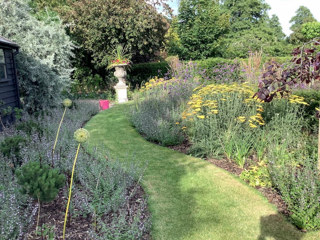How to design Create a Relaxation Garden creating your own relaxation garden design Essex Suffolk Curved lawn path through perennial planting